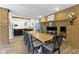 Dining area with table and fireplace in an open floor plan with view to kitchen at 17320 Joliet Rd, Westfield, IN 46074