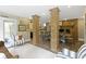 Inviting dining area featuring exposed brick columns and fireplace with wood floors and neutral color palette at 17320 Joliet Rd, Westfield, IN 46074