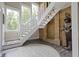 Bright entryway featuring an elegant staircase, brick accent wall, and stylish decor at 17320 Joliet Rd, Westfield, IN 46074