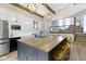 A kitchen with an island and counter seating shows appliances and a view to the living room at 17320 Joliet Rd, Westfield, IN 46074