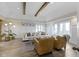 Bright living room with vaulted ceilings, wood beams, many windows, and luxury vinyl plank flooring at 17320 Joliet Rd, Westfield, IN 46074