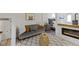 A cozy living room with a view of a bedroom, a fireplace, wood floors and stylish decor at 17320 Joliet Rd, Westfield, IN 46074