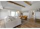 Bright living room with exposed beams, many windows, and luxury vinyl plank flooring at 17320 Joliet Rd, Westfield, IN 46074