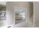 View of a spacious main bedroom featuring a bed with a tufted headboard and French doors at 17320 Joliet Rd, Westfield, IN 46074