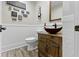 Elegant powder room with stylish vessel sink on a wood cabinet and decorative textured walls at 17320 Joliet Rd, Westfield, IN 46074
