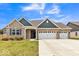 Charming single-story home with a well-manicured lawn, three-car garage and beautiful blue and brown accents at 1758 Pelham Dr, Greenwood, IN 46143