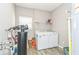 Functional laundry room featuring modern washer and dryer, water softener and durable vinyl flooring at 1758 Pelham Dr, Greenwood, IN 46143