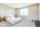 A minimalist main bedroom with carpet floors, a large window, and neutral decor to create a calm, restful space at 1758 Pelham Dr, Greenwood, IN 46143