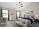 Spacious bedroom with vaulted ceilings, a cozy king-size bed, stylish decor, and large windows offering scenic views at 17877 Kinder Oak Dr, Noblesville, IN 46062