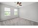 Bedroom featuring carpet, a ceiling fan, and natural light from two windows at 17877 Kinder Oak Dr, Noblesville, IN 46062