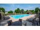 Large community pool surrounded by ample seating and lush landscaping, perfect for summer relaxation at 17877 Kinder Oak Dr, Noblesville, IN 46062