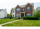 Inviting home with a brick facade, lush greenery, and manicured lawn at 17877 Kinder Oak Dr, Noblesville, IN 46062