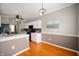 Eat-in kitchen features updated white cabinets, hardwood floors and modern lighting at 17877 Kinder Oak Dr, Noblesville, IN 46062
