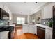 Bright eat-in kitchen features white cabinets, stainless appliances, and hardwood floors at 17877 Kinder Oak Dr, Noblesville, IN 46062