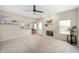 Open-concept living room with fireplace, carpet, access to the kitchen and outdoor deck at 17877 Kinder Oak Dr, Noblesville, IN 46062