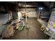 Unfinished basement featuring a sump pump and AO Smith water heater on concrete blocks at 1809 E 13Th St, Muncie, IN 47302