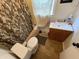 Modest bathroom featuring a standard toilet, vanity, and neutral shower curtain at 1809 E 13Th St, Muncie, IN 47302