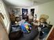 Cluttered bedroom interior with a bed, personal items, and natural light from a window at 1809 E 13Th St, Muncie, IN 47302
