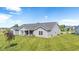 Landscaped backyard features a covered patio ideal for outdoor living and entertaining on a large lot at 19387 Astoria Ave, Sheridan, IN 46069