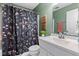 A full bathroom features a white vanity, and a shower with a floral shower curtain at 19387 Astoria Ave, Sheridan, IN 46069