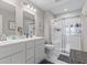 A bright bathroom featuring a double sink vanity and a glass-enclosed shower stall at 19387 Astoria Ave, Sheridan, IN 46069