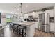 Modern kitchen boasts stainless steel appliances, granite countertops, and island with seating at 19387 Astoria Ave, Sheridan, IN 46069