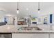 Bright kitchen featuring granite countertops, stainless steel sink, and open to the living room at 19387 Astoria Ave, Sheridan, IN 46069
