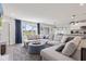 Comfortable living room with large windows, gray sectional, and open access to the kitchen at 19387 Astoria Ave, Sheridan, IN 46069