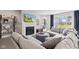 Comfortable living room features a fireplace, large sectional couch, and open floor plan at 19387 Astoria Ave, Sheridan, IN 46069