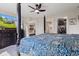 The bedroom features a four-poster bed, a TV, and access to the bathroom and the living room at 19387 Astoria Ave, Sheridan, IN 46069