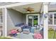 A covered patio with comfortable seating, a ceiling fan, and a view of the green lawn at 19387 Astoria Ave, Sheridan, IN 46069