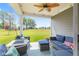 A covered patio with comfortable seating and a beautiful view of the lawn at 19387 Astoria Ave, Sheridan, IN 46069