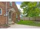 Brick home back exterior featuring a well-manicured lawn, complemented by landscaping and stone walkway at 1944 Union St, Columbus, IN 47201