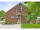 Brick home back exterior featuring a well-manicured lawn, complemented by landscaping and stone walkway at 1944 Union St, Columbus, IN 47201