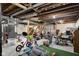 Unfinished basement with exposed ceiling, concrete floor, and a variety of stored items at 1944 Union St, Columbus, IN 47201