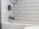 Close up of a shower and tub, with white subway tile, and fixtures at 1944 Union St, Columbus, IN 47201