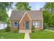 Charming brick home featuring a well-manicured lawn, complemented by vibrant landscaping and inviting curb appeal at 1944 Union St, Columbus, IN 47201