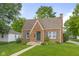 Charming brick home featuring a well-manicured lawn, complemented by vibrant landscaping and inviting curb appeal at 1944 Union St, Columbus, IN 47201