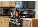 The kitchen features a black gas range, updated cabinets, and ample counter space at 1944 Union St, Columbus, IN 47201