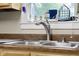 A stainless steel kitchen sink and faucet are installed below a bright window at 1944 Union St, Columbus, IN 47201