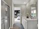 Bright bathroom featuring a glass shower, dual sinks, and a view of the Primary bedroom at 19791 Moorpark Lndg, Noblesville, IN 46062
