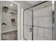 Modern bathroom featuring a glass-enclosed shower and convenient access to a walk-in closet at 19791 Moorpark Lndg, Noblesville, IN 46062