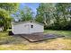 The backyard features a wooden deck perfect for outdoor dining and entertaining with ample green space and a storage building at 1993 Mulberry St, Noblesville, IN 46060