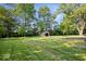Expansive backyard featuring mature trees and a storage shed, providing ample space for outdoor activities and storage at 1993 Mulberry St, Noblesville, IN 46060