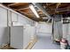 Unfinished basement laundry area featuring a washer, dryer, and exposed pipes at 1993 Mulberry St, Noblesville, IN 46060