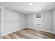 Simple bedroom featuring light colored walls, hardwood floors, and a bright window at 1993 Mulberry St, Noblesville, IN 46060