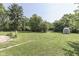 Expansive backyard featuring a large grassy area and a charming storage shed at 2245 N Ritter Ave, Indianapolis, IN 46218