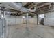 Unfinished basement area featuring concrete floors, white painted walls, and exposed ceiling at 2245 N Ritter Ave, Indianapolis, IN 46218