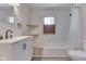 Updated bathroom with a modern vanity, shelves and tub/shower combo at 2245 N Ritter Ave, Indianapolis, IN 46218