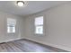 Bedroom featuring two windows with natural light and gray vinyl plank flooring at 2245 N Ritter Ave, Indianapolis, IN 46218